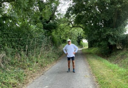 Runner Les Bailey standing on a countryside road.